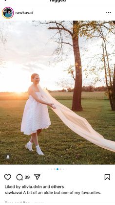 a woman in a white dress holding a long veil