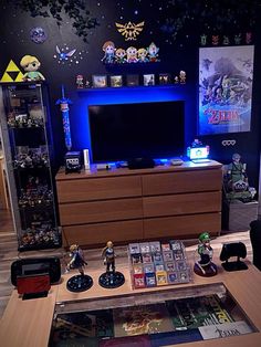 a living room filled with furniture and a tv on top of a wooden table in front of a blue light