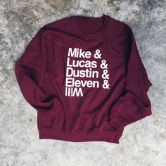 a maroon sweatshirt with the words mike and lucas and dustin eleven and tim on it