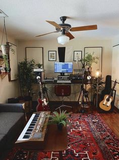 a living room filled with lots of furniture and a guitar sitting on top of a rug