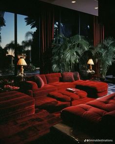 a living room filled with lots of red couches