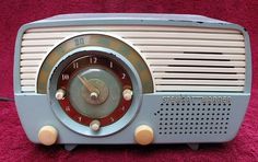 an old fashioned radio sitting on top of a red carpet