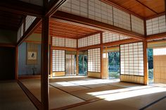 an empty room with tatami mats and windows