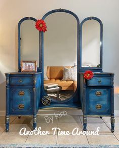 a blue dresser with a mirror on top of it