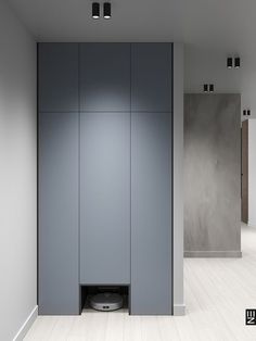 an empty room with grey cabinets and white floors