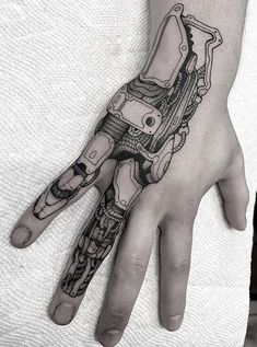 "Men's Hand Tattoos: The Ultimate Symbol of Strength and Style" Robot Finger Tattoo, Robot Knee Tattoo, Cyberpunk Hand Tattoo, Circuitry Tattoo, Bionic Arm Tattoo, Computer Tattoo Ideas, Gear Tattoo Design, Bionic Tattoo, Men's Hand Tattoos