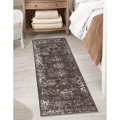 a brown and white rug in a bedroom