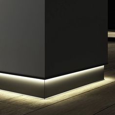 an empty room with some lights on the floor and a black wall in the background