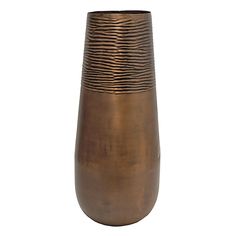 a large metal vase sitting on top of a white surface