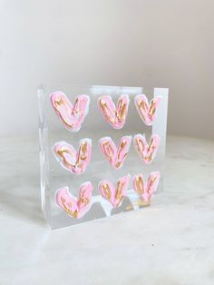 pink and gold heart shaped stickers in a clear plastic bag on a marble surface