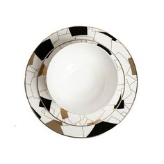 a black and white plate with gold trimmings on the edge, sitting in front of a white background