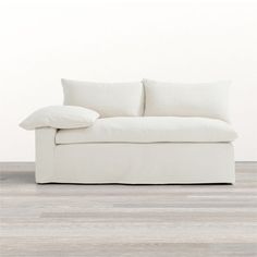 a white couch sitting on top of a wooden floor