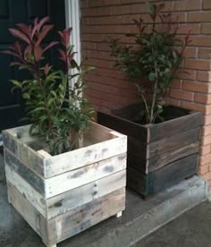 two wooden planters sitting on the side of a building