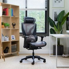 an office chair sitting in front of a computer monitor on top of a desk next to a window