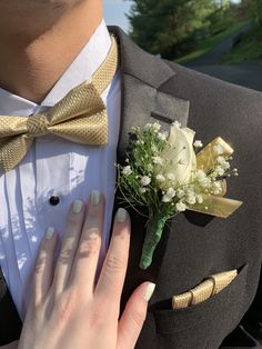 a person in a tuxedo with a boutonniere on their lapel