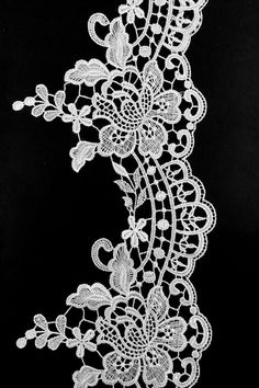 a white lace with flowers and leaves on it