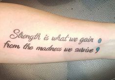 a tattoo saying strength is what we gain from the madees we survive on someone's arm