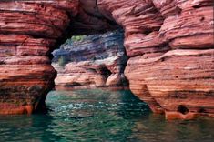 the water is crystal blue and clear in this photo, as well as red rock formations