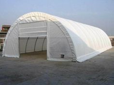 a large white tent sitting in the middle of a parking lot