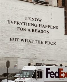 a fedex truck is parked in front of a building that says i know everything happens for a reason but what the f