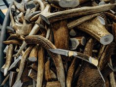 a large pile of wood and metal tools in it's storage bin, with the handles still attached to them