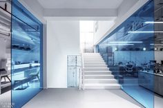 an office with glass walls and stairs