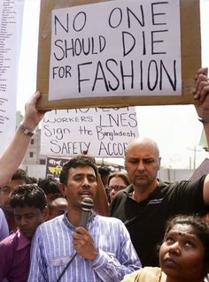 a group of people holding signs and microphones