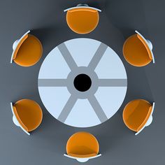 an overhead view of a round table with orange chairs