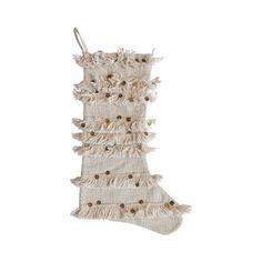 a christmas stocking with fringes and buttons hanging from the side on a white background