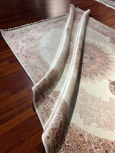 two large rugs laying on top of a wooden floor