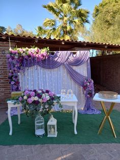 an outdoor wedding setup with purple and white flowers