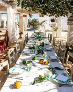 a long table with plates and place settings on it