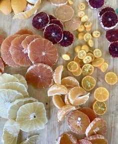 oranges, lemons and grapefruits cut up on a cutting board