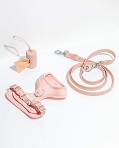 two leashes, one pink and the other light pink are laying next to each other