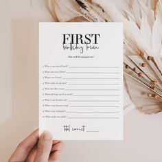 a person holding up a white paper with the words first birthday practice written on it