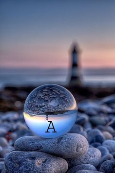 a glass ball sitting on top of some rocks