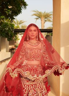 a woman in a red bridal gown and veil