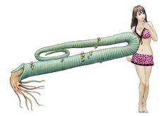 a woman in pink and black swimsuit holding up a large green snake like object