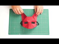 someone is making a paper dog mask on a cutting board