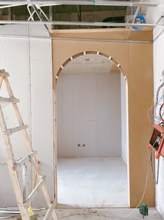 an unfinished room with a ladder in it