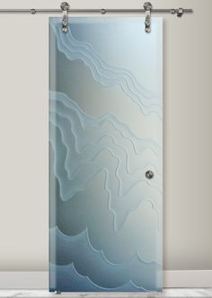 a glass door with an abstract design on the front and side panels in blue, white and grey