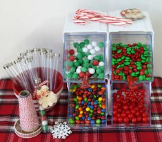 christmas candies in plastic containers and candy canes on a table with plaid cloth