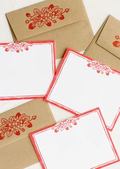 four envelopes with red and white flowers on them