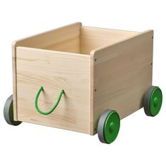 a wooden toy truck with green wheels and handles on the front, carrying a bag