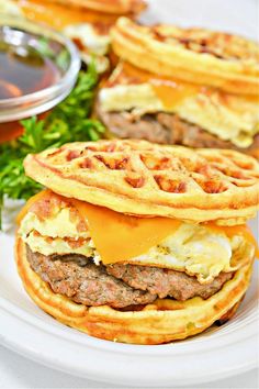 some waffle sandwiches are on a white plate