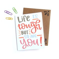 a card with the words life is tough, but so are you written on it