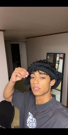 a young man wearing a black hat in his living room