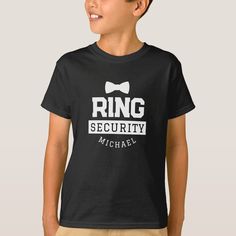 a young boy wearing a ring security t - shirt