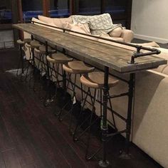 a long table with stools sitting in front of it