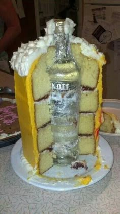 a cake that has been made to look like a house with a bottle on top